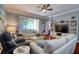 Comfortable living room with hardwood floors, ceiling fan, and stylish coastal decor at 1023 Orca Ct, Holiday, FL 34691