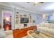 Living room featuring hardwood floors, a TV, and stylish coastal decorations at 1023 Orca Ct, Holiday, FL 34691