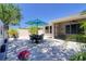 Relaxing patio with a table, seating, teal umbrella, and a screened-in lanai, perfect for entertaining at 1023 Orca Ct, Holiday, FL 34691