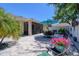 Inviting paver patio with dining set, umbrella, and screened-in lanai, perfect for outdoor relaxation at 1023 Orca Ct, Holiday, FL 34691