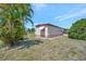 Home exterior surrounded by green lawn and mature palm trees in a beautiful setting at 104 Saint Kitts Way, Apollo Beach, FL 33572