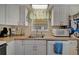 Close-up of kitchen area featuring efficient appliances and storage at 104 Saint Kitts Way, Apollo Beach, FL 33572