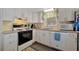 Functional kitchen with white cabinets, appliances, and ample countertop space at 104 Saint Kitts Way, Apollo Beach, FL 33572