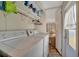 Convenient laundry room featuring washer, dryer, and storage shelves for efficient organization at 104 Saint Kitts Way, Apollo Beach, FL 33572