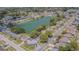 Aerial view of neighborhood showcasing a centrally-located lake surrounded by single-Gathering homes at 10809 Collar Dr, San Antonio, FL 33576