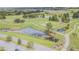 Aerial view of the golf course and surrounding pond with lush greenery at 10809 Collar Dr, San Antonio, FL 33576