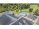 Aerial view of the community pool, shuffleboard court, and surrounding landscaping at 10809 Collar Dr, San Antonio, FL 33576