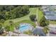 An aerial view shows the community pool and nearby golf course at 10809 Collar Dr, San Antonio, FL 33576