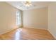 Bright bedroom featuring light walls, ceiling fan, laminate floors, and a sunny window at 10809 Collar Dr, San Antonio, FL 33576