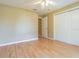 Bright bedroom with wood-look floors, neutral walls and a closet with sliding doors at 10809 Collar Dr, San Antonio, FL 33576