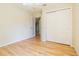 Bedroom with sliding closet doors and an open door to a hallway at 10809 Collar Dr, San Antonio, FL 33576