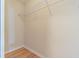 Walk in closet with metal shelf and clothing rod and light tan walls at 10809 Collar Dr, San Antonio, FL 33576