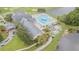 Aerial view of community center with swimming pool, lounge chairs, and well-manicured lawns at 10809 Collar Dr, San Antonio, FL 33576