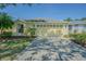Charming one-story home with a well-manicured lawn, sunny yellow paint and attached two car garage at 10809 Collar Dr, San Antonio, FL 33576