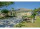 Charming one-story home with a well-manicured lawn, sunny yellow paint and attached two car garage at 10809 Collar Dr, San Antonio, FL 33576