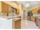 Bright kitchen with stainless steel refrigerator and wooden cabinets at 10809 Collar Dr, San Antonio, FL 33576