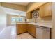 Kitchen features light-colored cabinetry and stainless steel dishwasher at 10809 Collar Dr, San Antonio, FL 33576