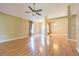 Spacious living room with wood-look floors and neutral walls with entry to front door at 10809 Collar Dr, San Antonio, FL 33576