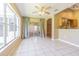 Open-concept living room with tile floors and large windows overlooking the lanai at 10809 Collar Dr, San Antonio, FL 33576