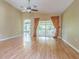 Open living room with vaulted ceilings and laminate flooring with a view to the sunroom at 10809 Collar Dr, San Antonio, FL 33576