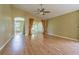 Bright living room with view of sunroom and laminate flooring at 10809 Collar Dr, San Antonio, FL 33576