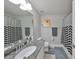 Stylish bathroom featuring granite counters, chevron shower curtain, and modern fixtures at 10947 Verawood Dr, Riverview, FL 33579