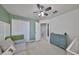 Neutral colored room with modern dresser, grey couch, white door and closet at 10947 Verawood Dr, Riverview, FL 33579