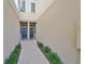 Inviting walkway between units with two front doors, enhanced with charming landscaping at 10947 Verawood Dr, Riverview, FL 33579