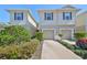 Well-maintained townhome with a two-car garage and beautifully landscaped front yard at 10947 Verawood Dr, Riverview, FL 33579