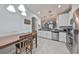Open-concept kitchen boasts stainless steel appliances and white cabinetry at 10947 Verawood Dr, Riverview, FL 33579