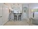 Open-concept kitchen with bar seating and pendant lighting, seamlessly connected to the living space at 10947 Verawood Dr, Riverview, FL 33579