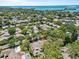 Desirable community with mature trees in an aerial view close to the beach, showcasing nearby water and lush greenery at 110 Parkside Colony Dr, Tarpon Springs, FL 34689