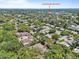 Aerial view showing neighborhood with homes and trees. Tarpon Springs High School in view at 110 Parkside Colony Dr, Tarpon Springs, FL 34689