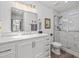 Updated bathroom featuring a sleek vanity with quartz counters and walk-in shower with marble tile at 110 Parkside Colony Dr, Tarpon Springs, FL 34689