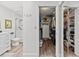 Modern bathroom with a marble shower, vanity, and toilet, with adjacent walk in closet at 110 Parkside Colony Dr, Tarpon Springs, FL 34689