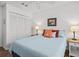 Comfortable bedroom featuring a bed with decorative pillows, side tables, and ample closet space at 110 Parkside Colony Dr, Tarpon Springs, FL 34689