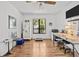 Sunlit bedroom featuring hardwood floors, a ceiling fan, and a large window at 110 Parkside Colony Dr, Tarpon Springs, FL 34689