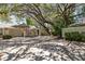 Inviting single-story home with mature trees, an American flag, and a two-car garage at 110 Parkside Colony Dr, Tarpon Springs, FL 34689