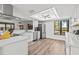 Bright, modern kitchen with stainless steel appliances, stylish lighting, and a view to the backyard at 110 Parkside Colony Dr, Tarpon Springs, FL 34689