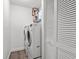 Functional laundry room equipped with a washer, dryer, shelving, and closet for convenient storage at 110 Parkside Colony Dr, Tarpon Springs, FL 34689