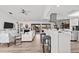 Open-concept living room and kitchen, featuring modern furnishings and access to the outdoor patio at 110 Parkside Colony Dr, Tarpon Springs, FL 34689