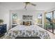 Bright main bedroom with ceiling fan, bedside tables, and artwork at 110 Parkside Colony Dr, Tarpon Springs, FL 34689