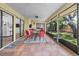 Covered patio area with tile floor and outdoor dining set at 110 Parkside Colony Dr, Tarpon Springs, FL 34689
