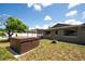 Spacious backyard featuring a hot tub, fire pit, and screened-in porch at 11797 David Ct, Largo, FL 33778