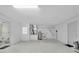Unfinished basement with a water heater, utility sink, and small half bathroom at 11797 David Ct, Largo, FL 33778