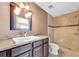 Bathroom featuring a granite vanity, a walk-in shower, and tiled walls at 11797 David Ct, Largo, FL 33778