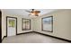 Neutral bedroom with tile flooring, a ceiling fan, and natural light from exterior windows at 11797 David Ct, Largo, FL 33778