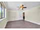This bedroom features wood floors, a ceiling fan, and a closet with sliding doors at 11797 David Ct, Largo, FL 33778