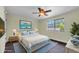 Bright bedroom featuring a large window and beach themed decor at 11797 David Ct, Largo, FL 33778