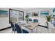 Bright dining room with matching blue accents and beach themed decor at 11797 David Ct, Largo, FL 33778